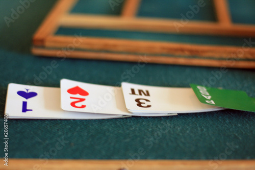 equipment to bridge playing: green tables, biding box