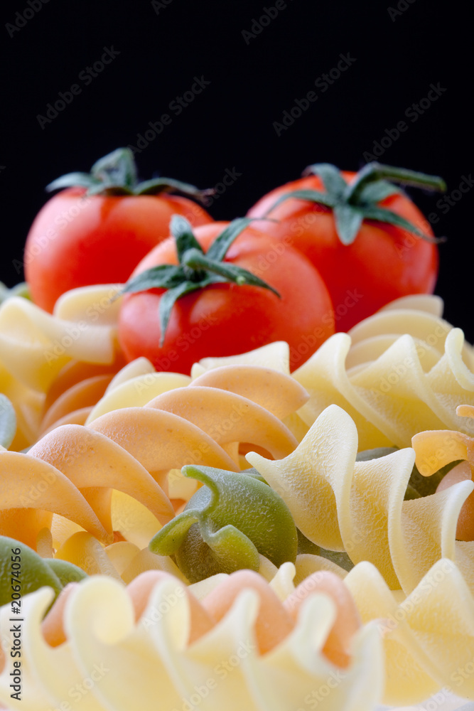 Colorful Dry Italian Pasta On Black Background. Focus on pasta.