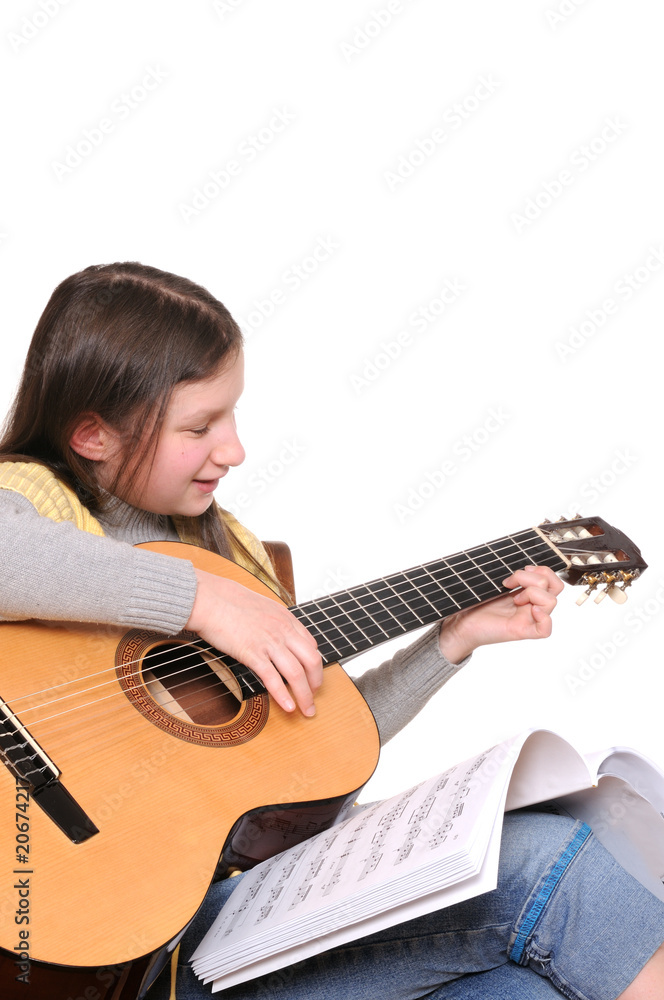 Fototapeta premium Girl learning to play guitar