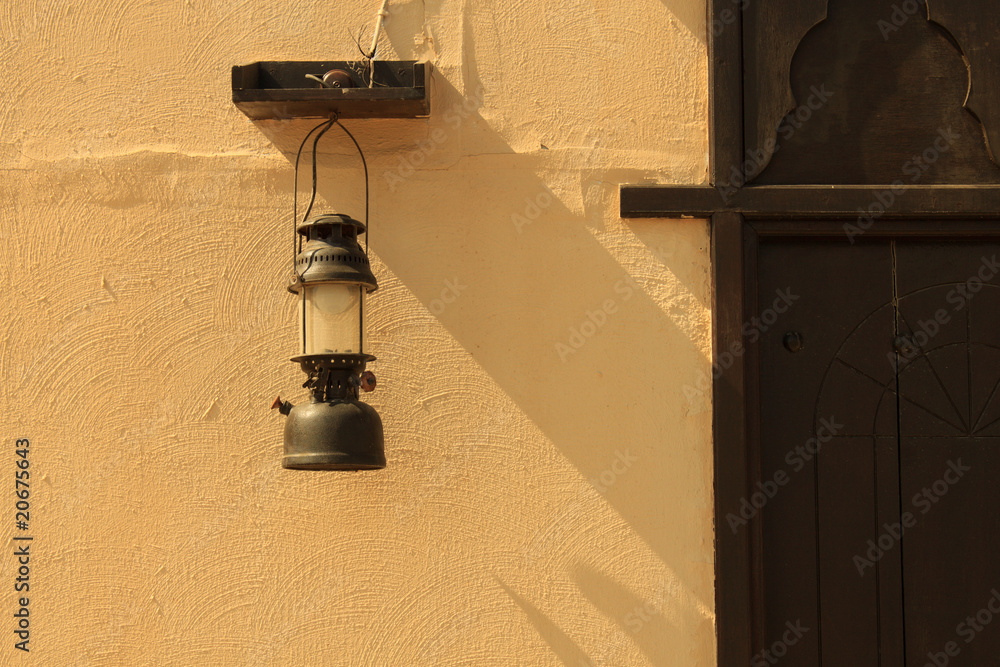 Fototapeta premium antique arabic lamp lantern with textured wall and door