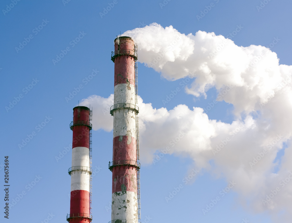 Two smoking towers against the pure blue sky. Two smoking towers against the pure blue sky.
