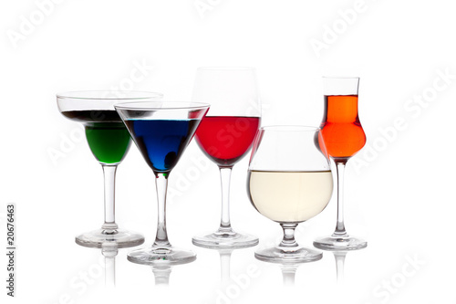 different colored drinks in wineglasses