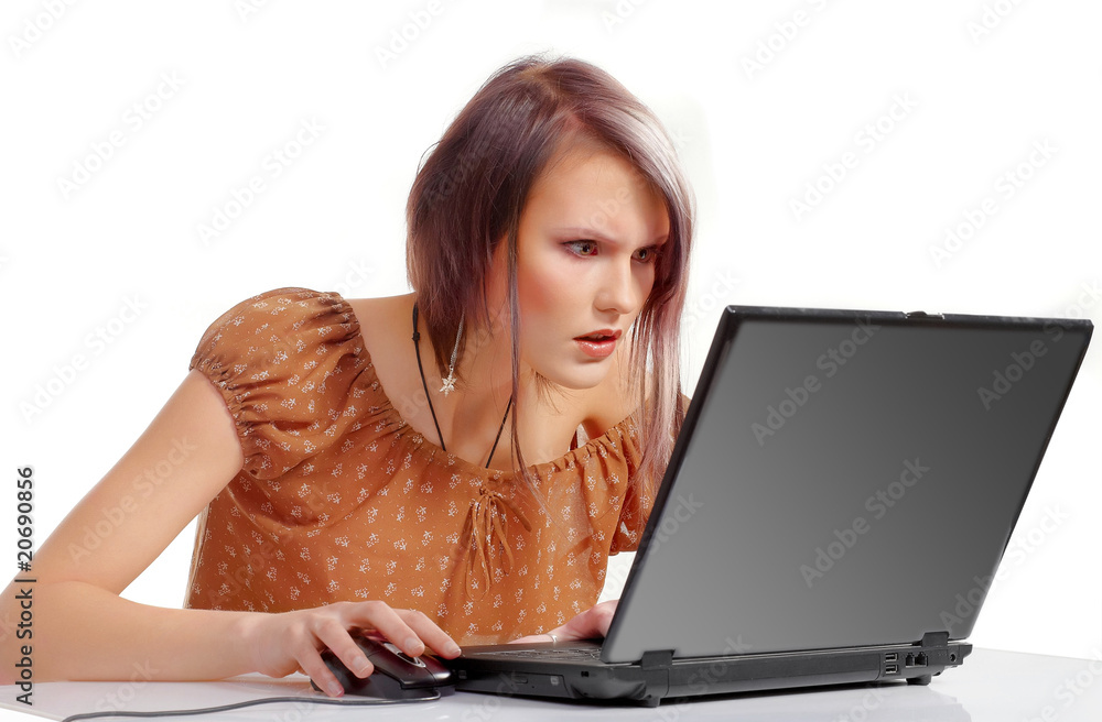 Naklejka premium Surprised young girl with laptop and head phones