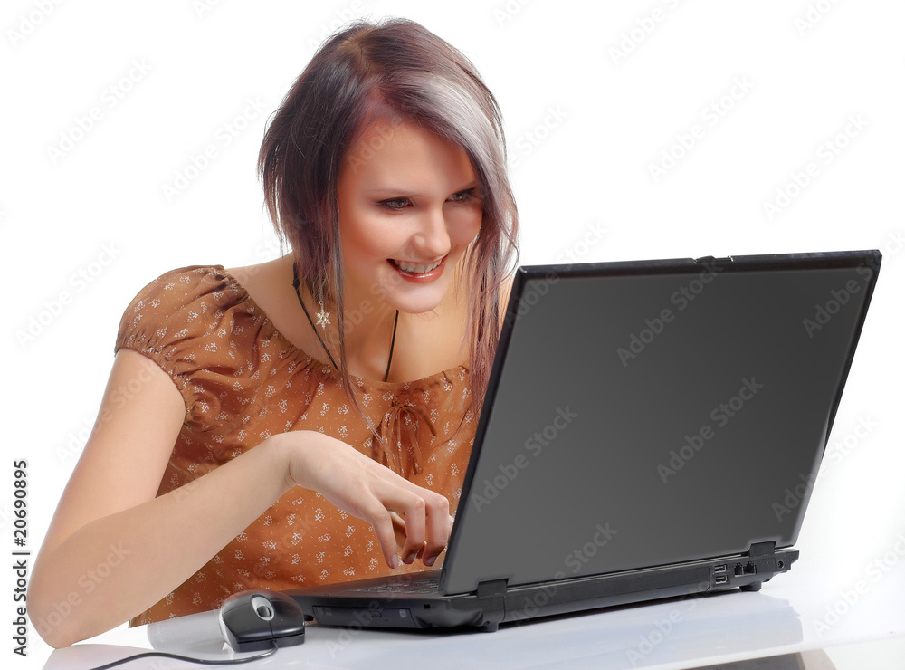 The girl sitting at the laptop on a white background The girl sitting at the laptop on a white background