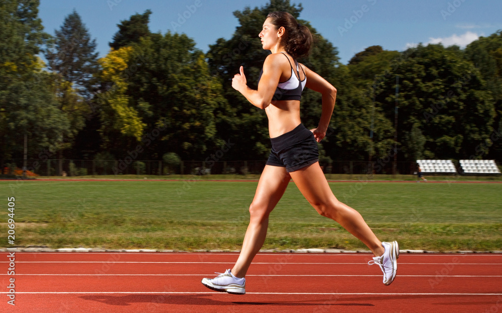 dynamic image of a young woman running on a track