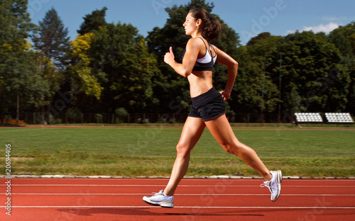 dynamic image of a young woman running on a track