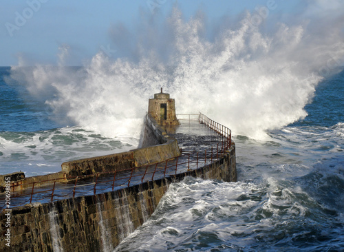 Big wave splash on Portreath pier, Cornwall UK. photo