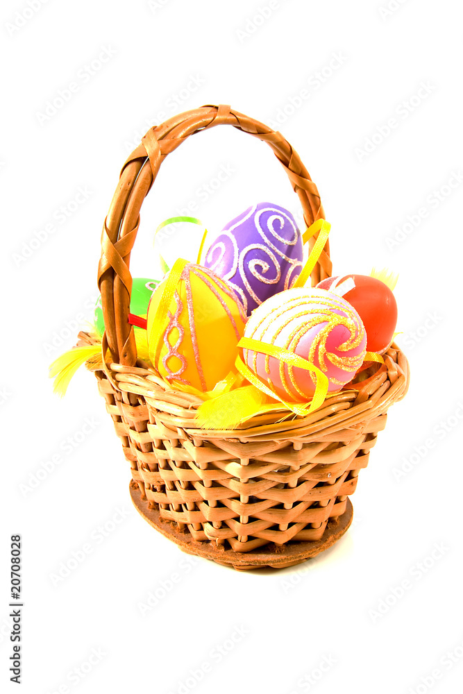 Basket with colorful easter eggs over white background