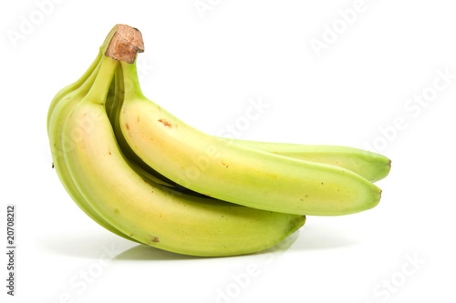 Spray of fresh bananas over white background