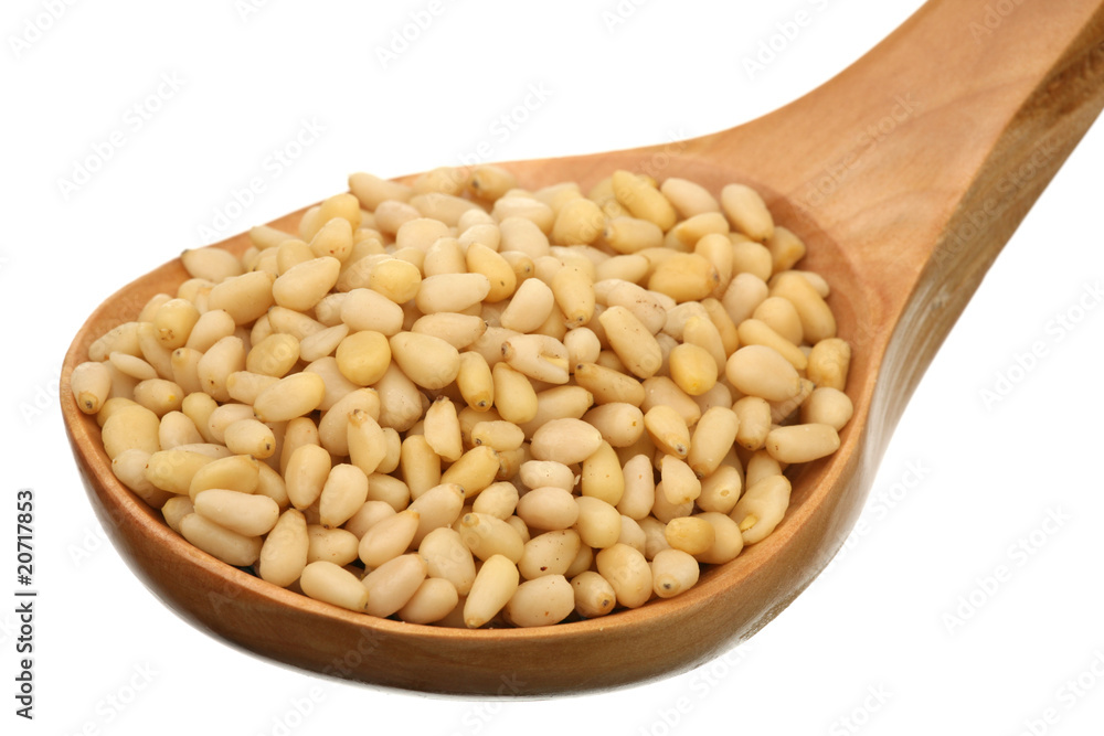 Pine nuts in a wooden spoon Pine nuts in a wooden spoon