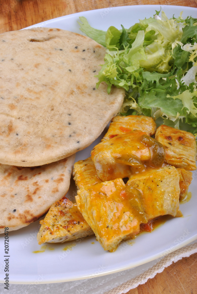 naan bread with turkey curry on a plate naan bread with turkey curry on a plate