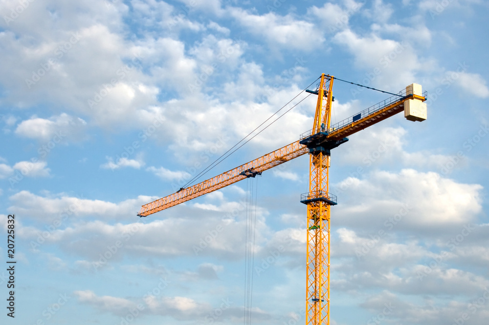 Construction crane against the sky with clouds Construction crane against the sky with clouds