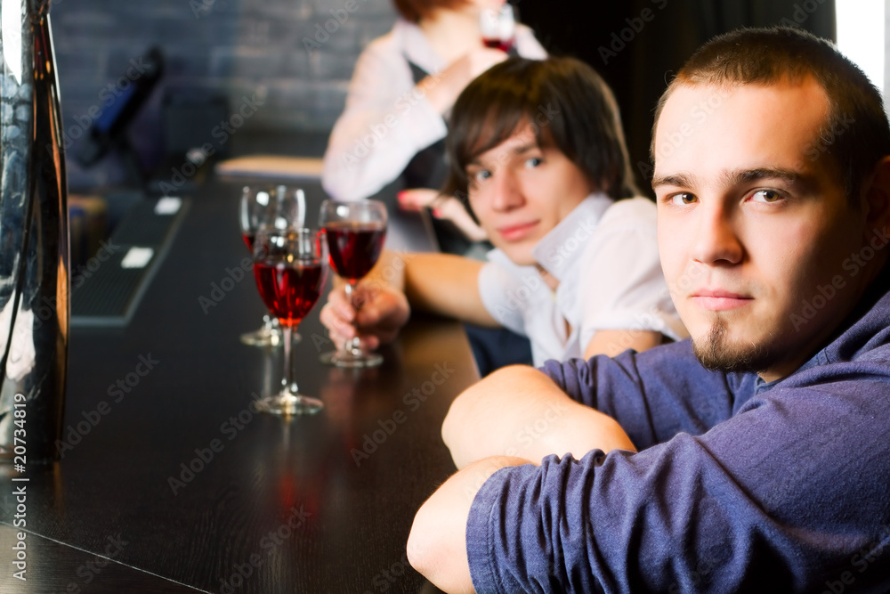 Young men relaxing on a bar counter. Young men relaxing on a bar counter.