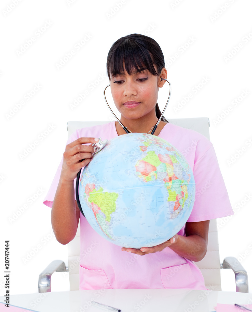 Portrait of an ethnic doctor examining a terrestrial globe Portrait of an ethnic doctor examining a terrestrial globe