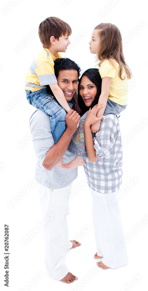 Happy young parents giving piggyback ride to their children Happy young parents giving piggyback ride to their children