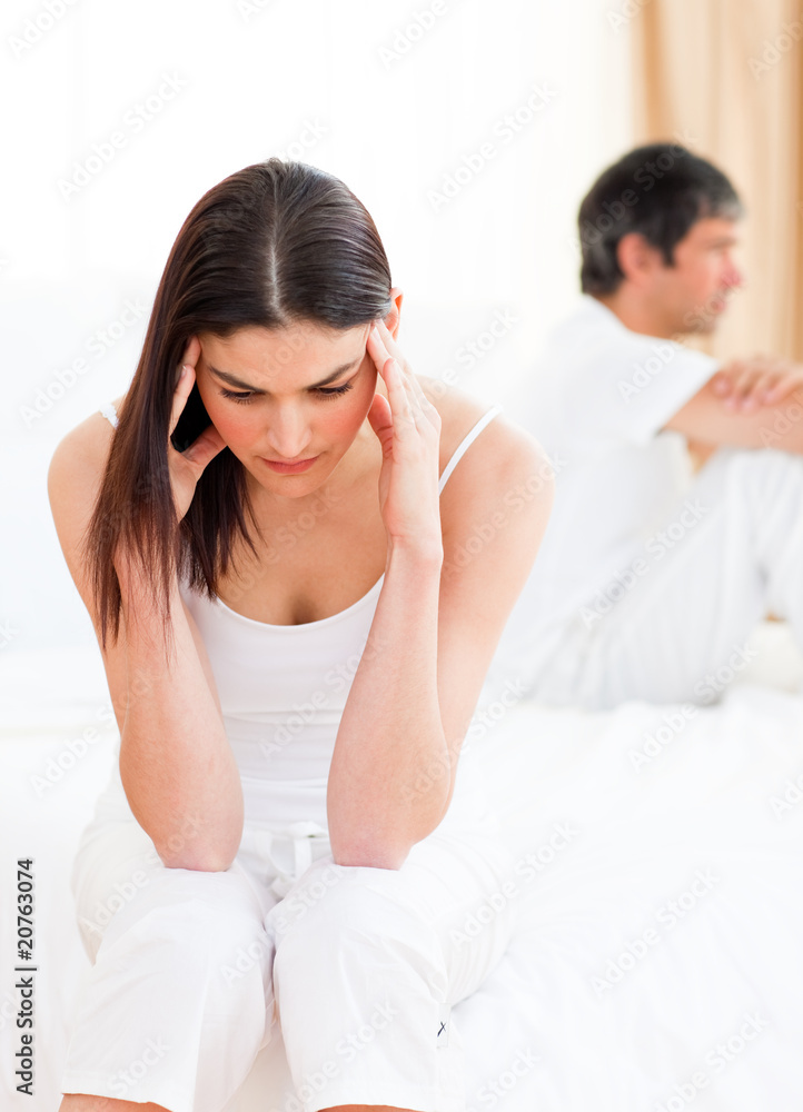 Distress couple sitting sitting separately after having a row Distress couple sitting sitting separately after having a row