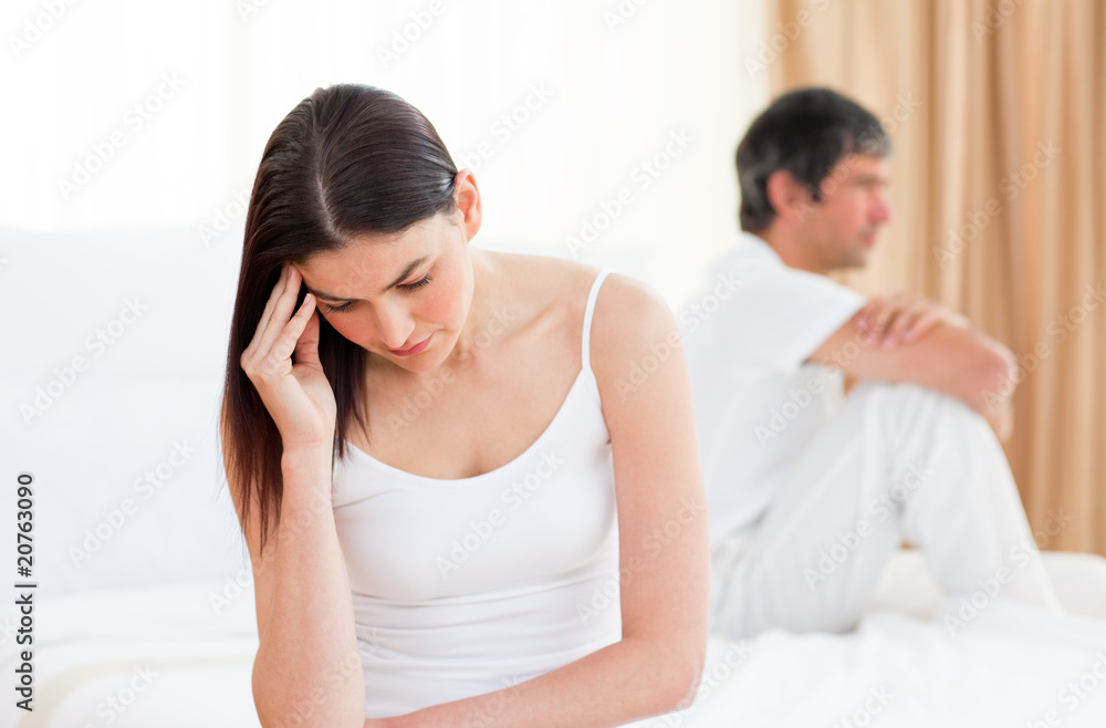 Upset couple sitting sitting separately after having a row Upset couple sitting sitting separately after having a row