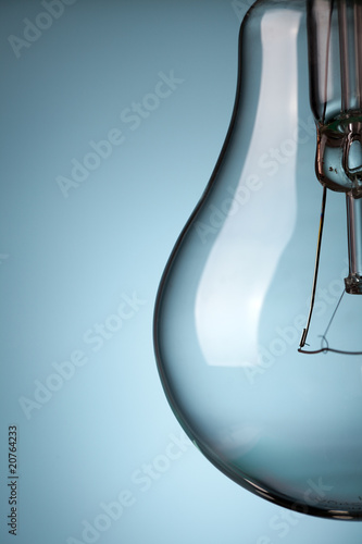 detail of light bulb on blue background