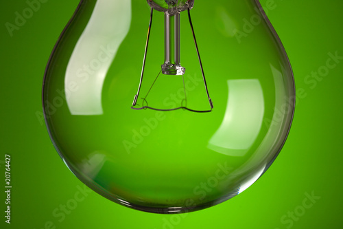 detail of light bulb on green background