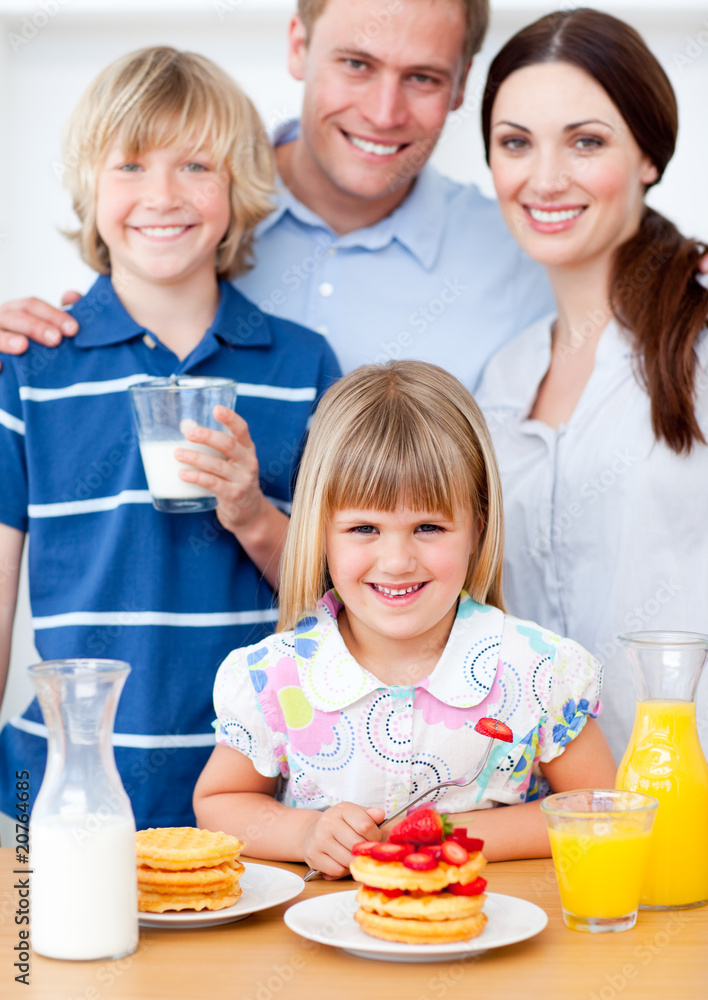 Joyful family eating breakfast in the kitchen Joyful family eating breakfast in the kitchen
