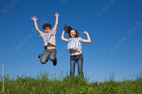 Girl and boy jumping, running outdoor