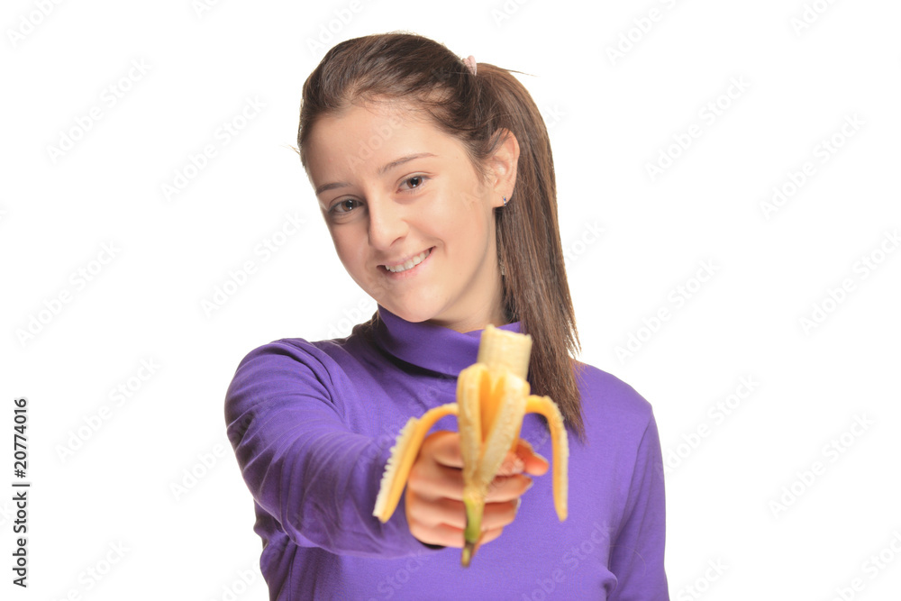 Cute girl holding a banana isolated against white Cute girl holding a banana isolated against white