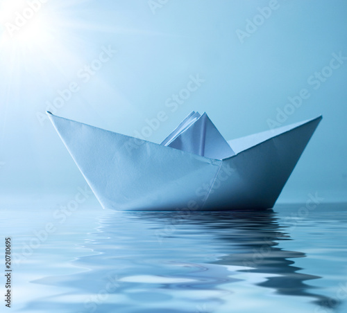 concept paper ship in water and sunny blue sky
