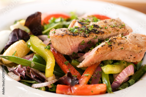 Grilled tuna steak with vegetables and salad. Shallow DOF