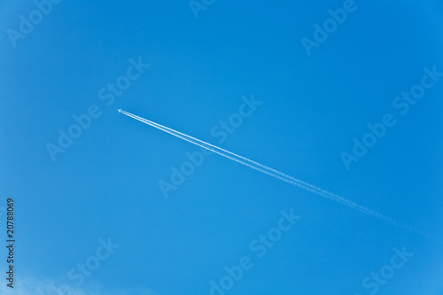 beautiful blue sky with condension trail of an aircraft