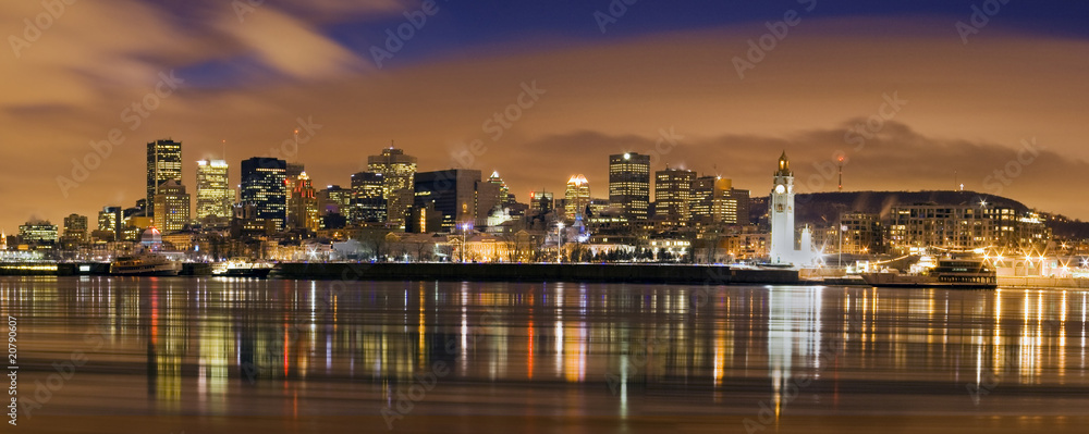 Fototapeta premium downtown skyline panorama at dusk in Montreal Canada with river