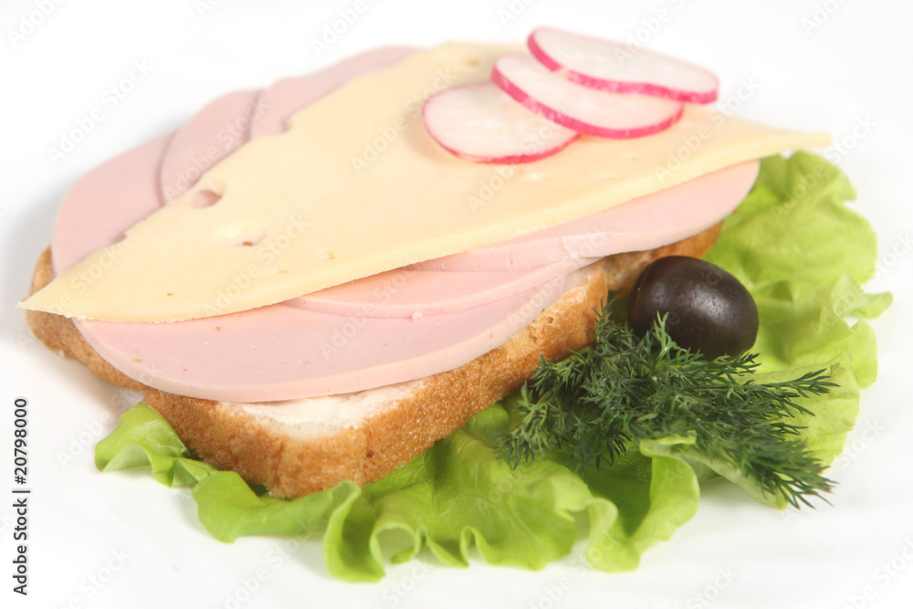 Ham sandwich with cheese, olives, radish and greenery