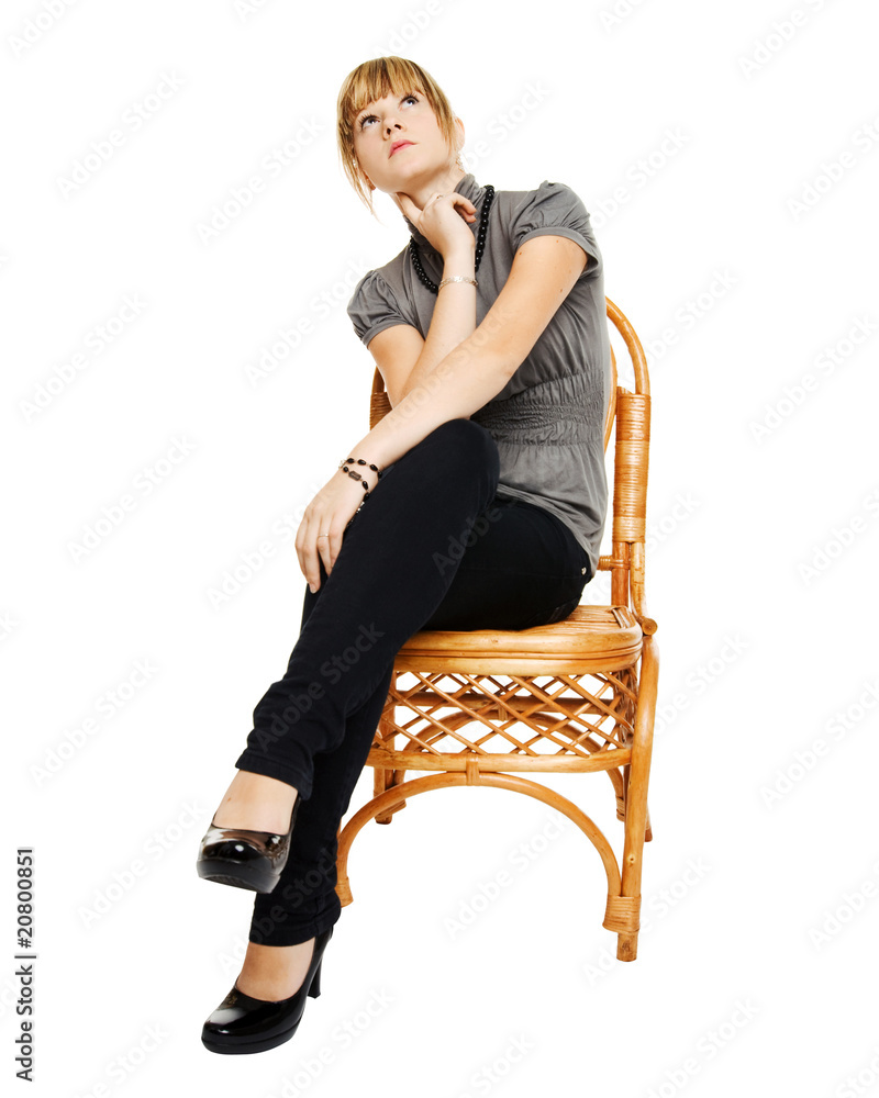 Fototapeta premium Young woman sitting on a chair