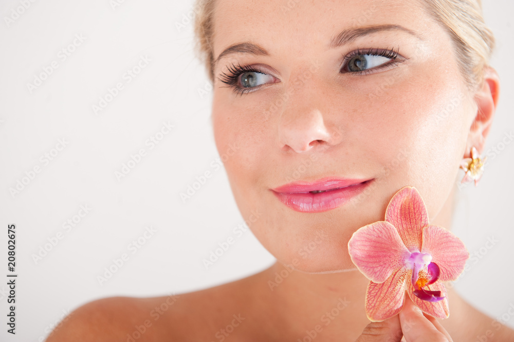 Young beautiful woman with clean healthy skin and orchid Young beautiful woman with clean healthy skin and orchid