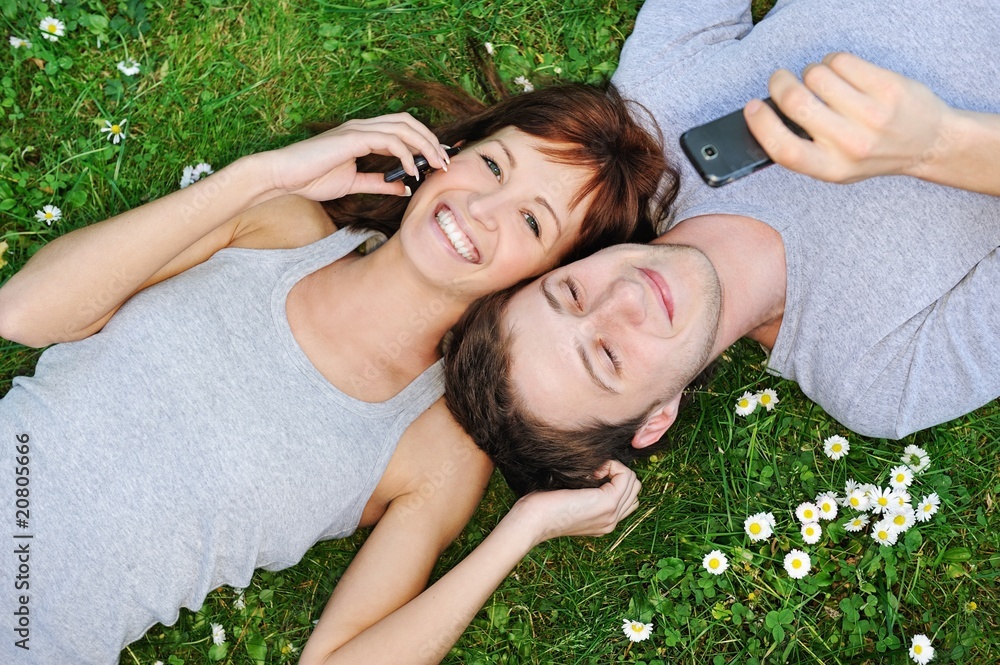 Young couple with mobile phones outdoor Young couple with mobile phones outdoor