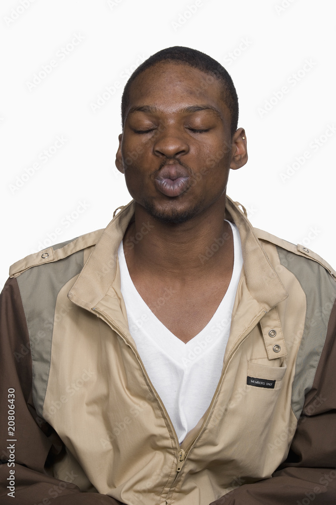 Portrait of Young Man Puckering Lips. Isolated. Portrait of Young Man Puckering Lips. Isolated.