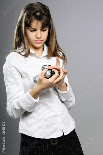 white teenager studying photo camera