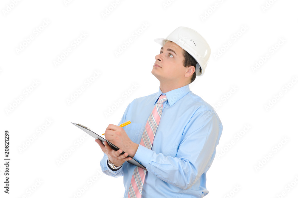 An engineer with white hard hat holding clipboard An engineer with white hard hat holding clipboard