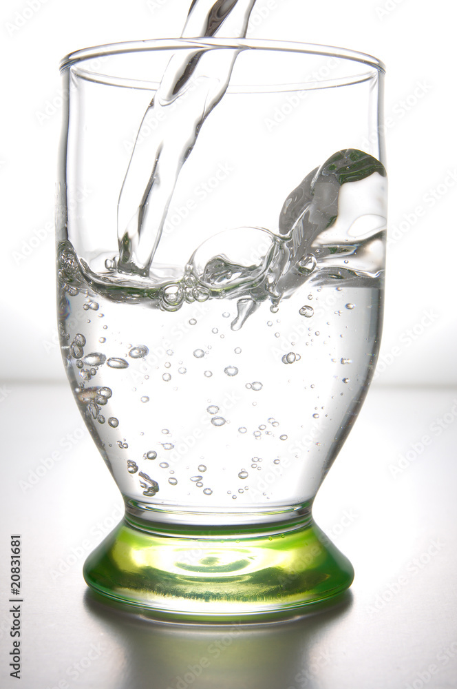 Fresh water pouring in a transparent glass Fresh water pouring in a transparent glass