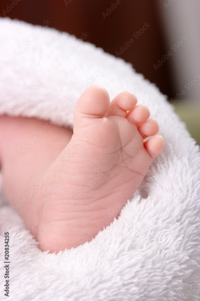 Adorable toddler's foot on white blanket Adorable toddler's foot on white blanket