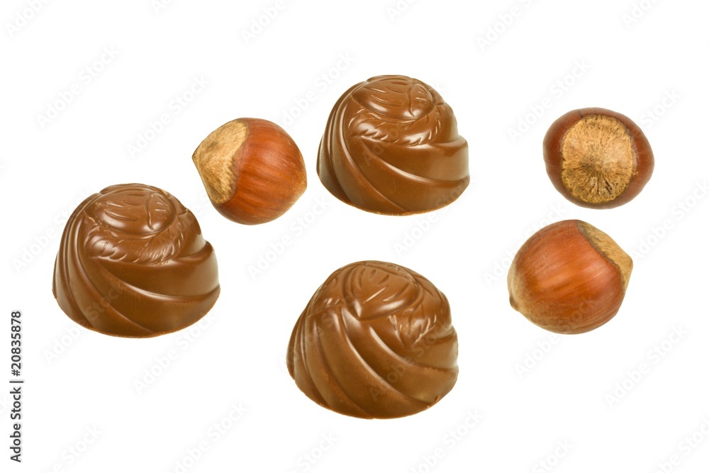 Chocolates and hazelnuts isolated on a white background Chocolates and hazelnuts isolated on a white background