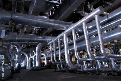 Pipes, tubes, machinery and steam turbine at a power plant.