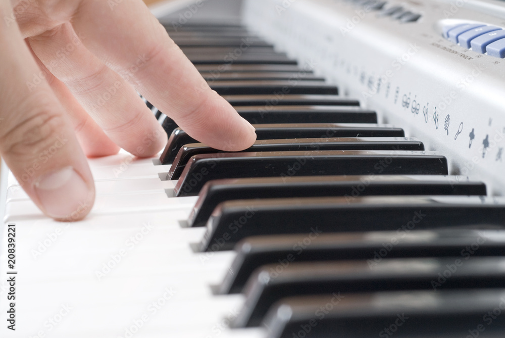 Fototapeta premium hand playing music on the piano