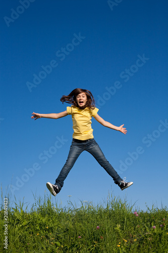 Girl jumping  running against blue sky