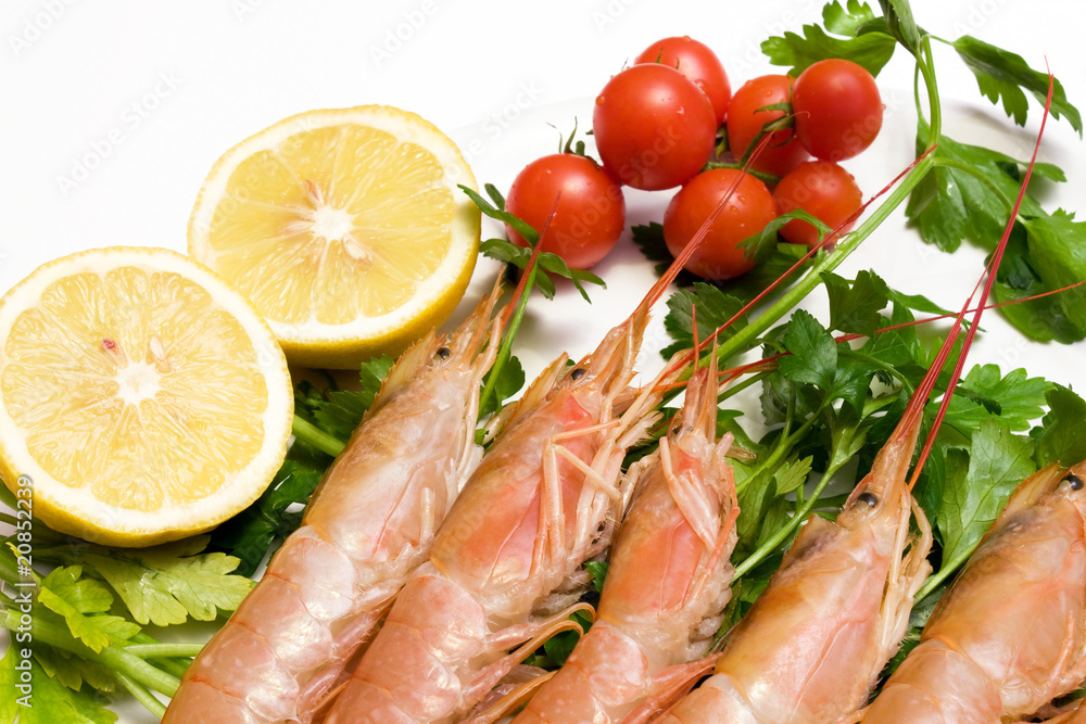 Plate with prawns parsley cherry tomatoes and lemon