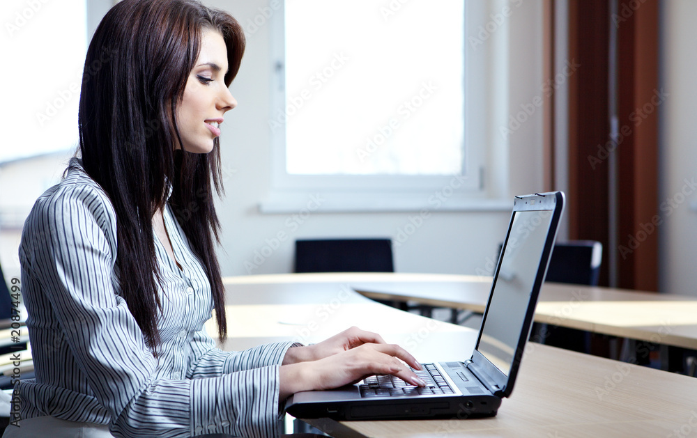 Beautiful business woman at the office smiling Beautiful business woman at the office smiling