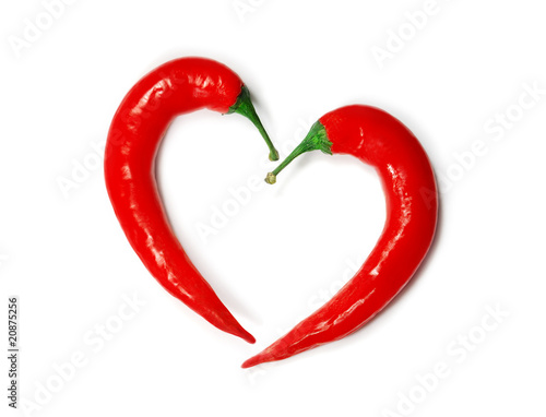 Two chili peppers forming a shape of heart. Hot lover symbol.