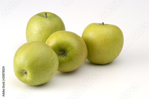 4 green apples on white
