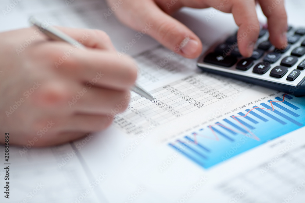 Financial data analyzing. Counting on calculator. Financial data analyzing. Counting on calculator.