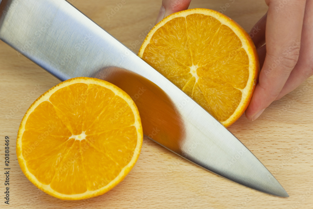 Chef Slicing Fresh Orange With Sharp Kitchen Knife Chef Slicing Fresh Orange With Sharp Kitchen Knife