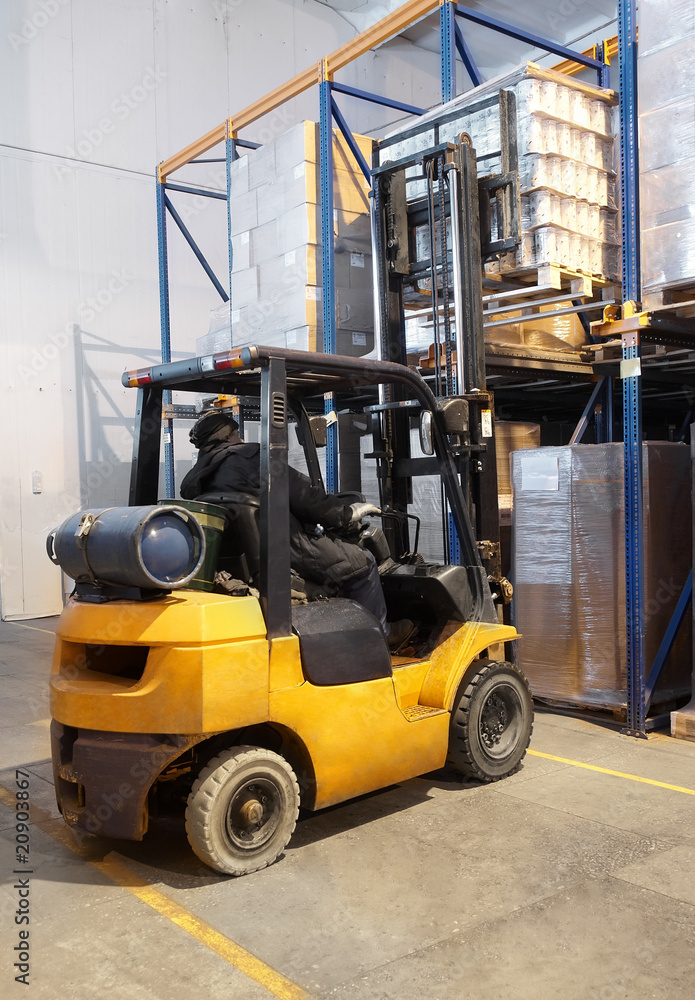 forklift loader stacking in warehouse